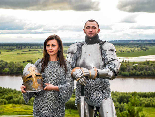 istock Knight with his lady in armor and chain mail. 1067380388