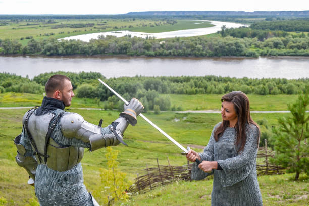 istock lady in chain mail and a knight in armor 1067380592