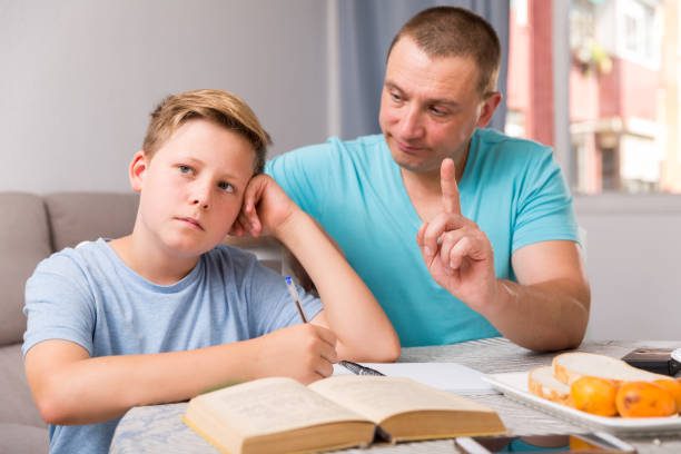istock Guy and his father are conflicting in time doing homework 1067382780