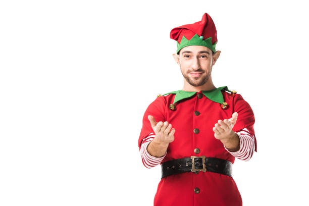 istock man in christmas elf costume with outstretched hands gesture looking at camera isolated on white 1067384066