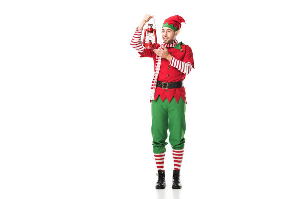 istock smiling man in christmas elf costume holding red lantern isolated on white 1067385274