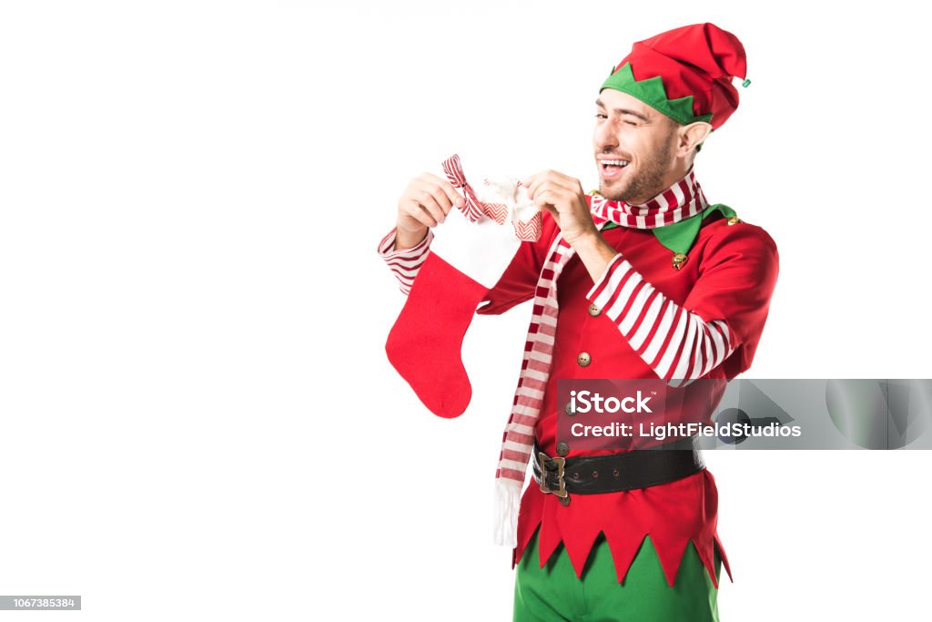 Foto de Homem Em Traje De Duende De Natal Presente Voando E Colocar Na Meia  De Natal Vermelho Isolado No Branco e mais fotos de stock de Adulto - iStock