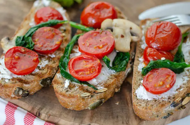 Healthy sandwich with Wholemeal Bread Toast and  with Cream cheese ,green spinach,olive oil mushrooms and tomatoes,