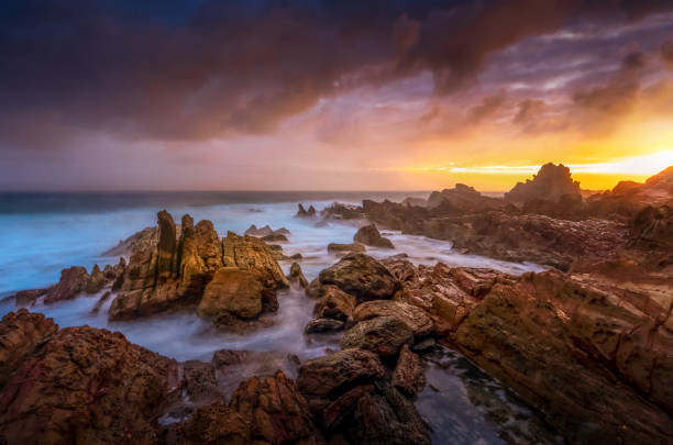 istock Sunlight filteres through storm clouds after rain on the coast 1067385554