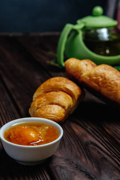 istock fresh croissants with jam on dark wooden table and tea on background 1067385688