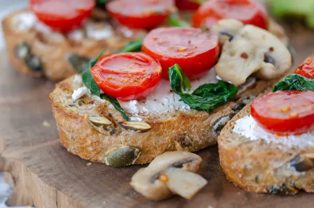 Healthy sandwich with Wholemeal Bread Toast and  with Cream cheese ,green spinach,olive oil mushrooms  and tomatoes,