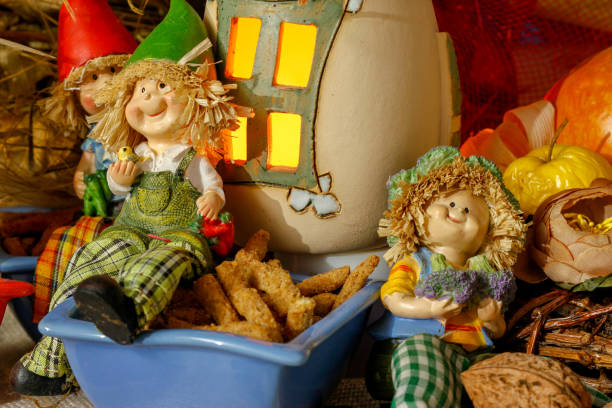 istock Beautiful composition iwith figurines of child's, snacks, dry leaves, walnuts and rustic decoration 1067386932