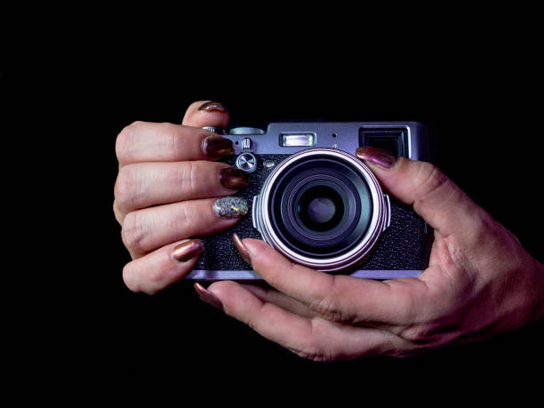 istock Classic looks camera in hands on dark background 1067390016