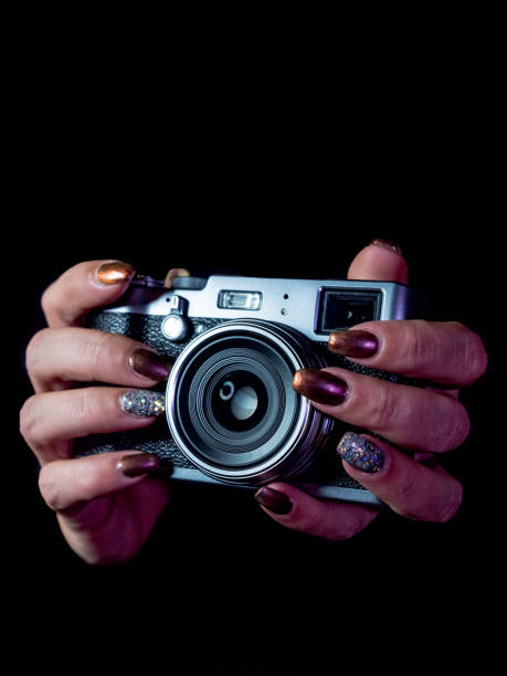 istock Classic looks camera in hands on dark background 1067390136