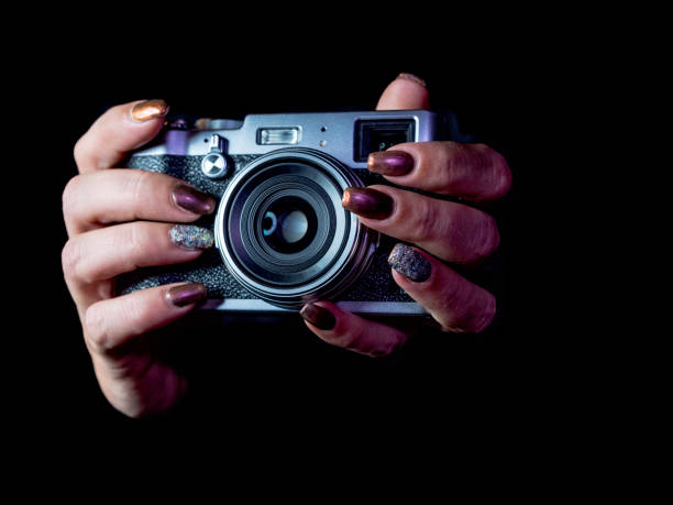 istock Classic looks camera in hands on dark background 1067390184