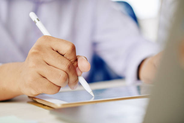 istock Crop man working on tablet with stylus 1067397562