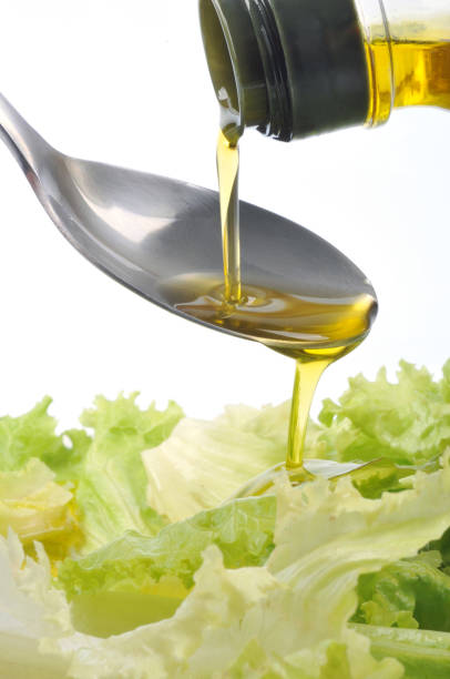 istock Pour olive oil into the salad 1067401648