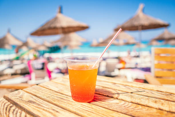 istock juice color cocktail during touristic vacation. umbrellas 1067401654