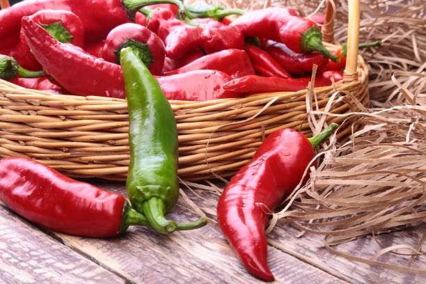 istock Wicker basket full of fresh red chili peppers. 1067403962