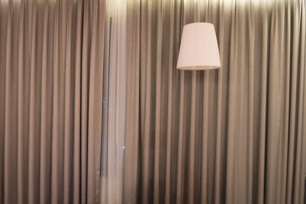istock Beautiful ceiling lamp with a curtain. Lighting fixture. 1067404422