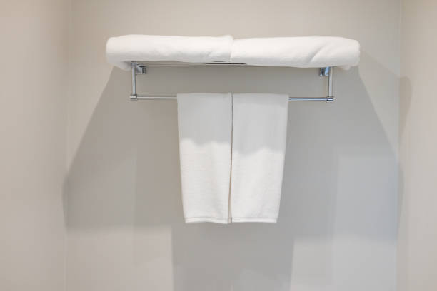 istock White towels on metal rack mounted on wall in bathroom 1067404532