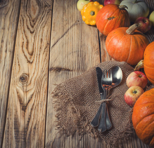 istock Tableware, pampkins and apple on the wood background 1067414242