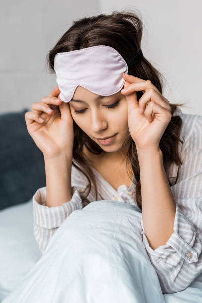 istock attractive girl with sleeping eye mask on head 1067414922