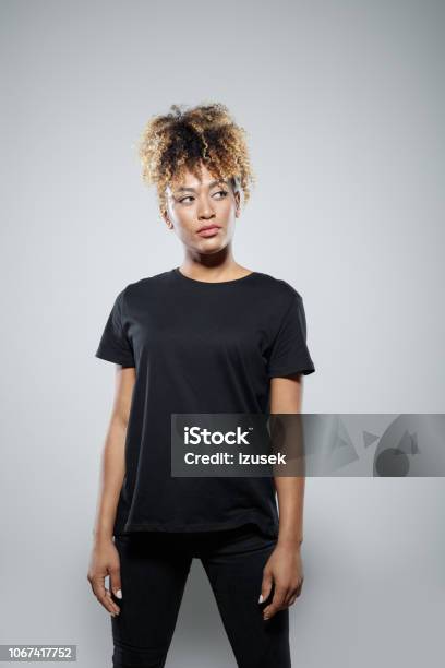 Portrait Of Confident Young Woman Stock Photo - Download Image Now - Afro Hairstyle, Looking Away, One Woman Only