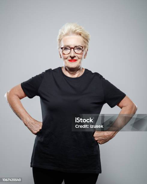 Portrait Of Confident Senior Woman Smiling At Camera Stock Photo - Download Image Now