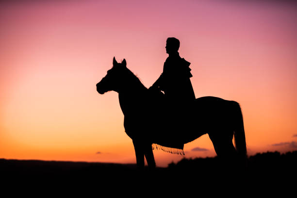 istock Horses and Men Silhouette at Sunset on a High Mountain 1067424300