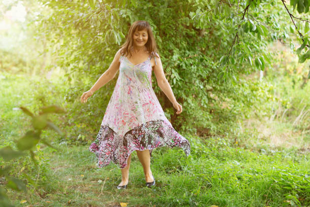 istock Summer: senior woman dancing in garden 1067427478