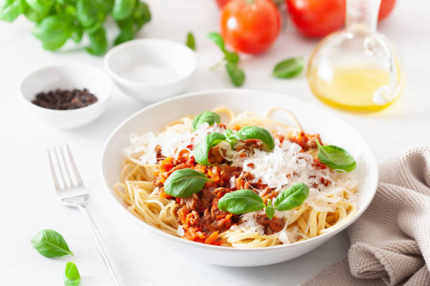 istock spaghetti bolognese with basil and parmesan, italian pasta 1067429426