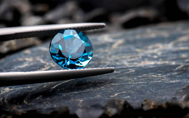 Blue topaz gemstone jewelry. Blue topaz gemstone jewelry photo with black stone and dark lighting. topaz stock pictures, royalty-free photos & images