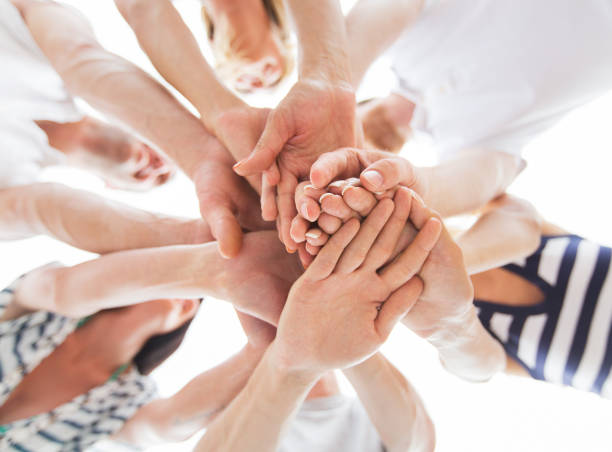 istock close up of friends with hands on top 1067430954