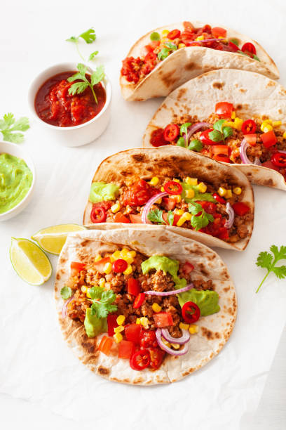 istock mexican beef and pork tacos with salsa, guacamole and vegetables 1067432910
