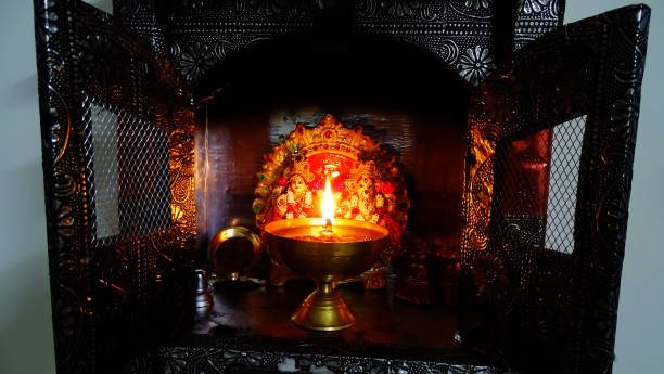 Temple at home Temple at home with burning oil lamp in front of lord Ganesha. kapaleeswarar temple photos stock pictures, royalty-free photos & images