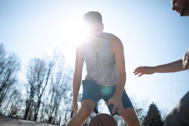 istock Friends playing basketball 1067435856