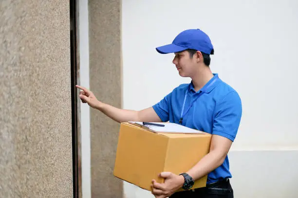 Delivery man hand ringing doorbell.
