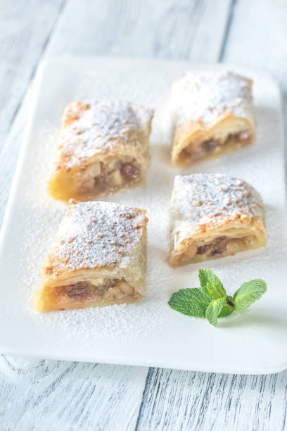 istock Slices of apple strudel on the white plate 1067437288