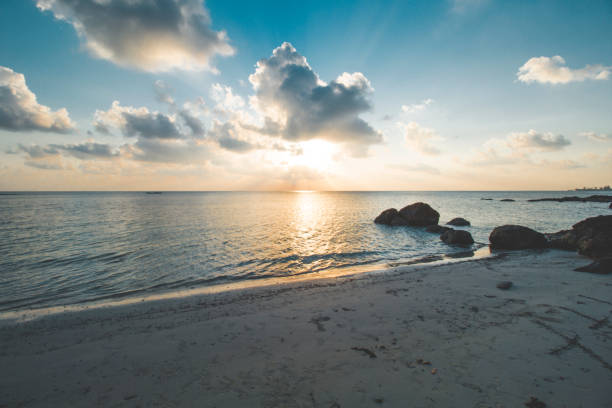 istock Sunset, Cloudy Orange Sky, Calm Wave and Beautiful Tropical Beach 1067438182