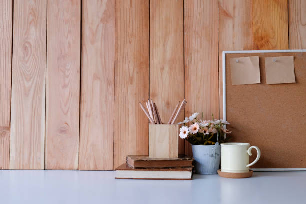 istock Workspace with copy space coffee mug, flower, wood board and sticky note with pencil on office desk. 1067439924