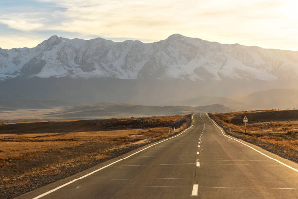 istock road mountains sunset autumn sunshine 1067442816