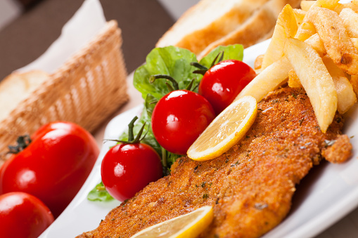 Schnitzel and fried potatoes and garniture