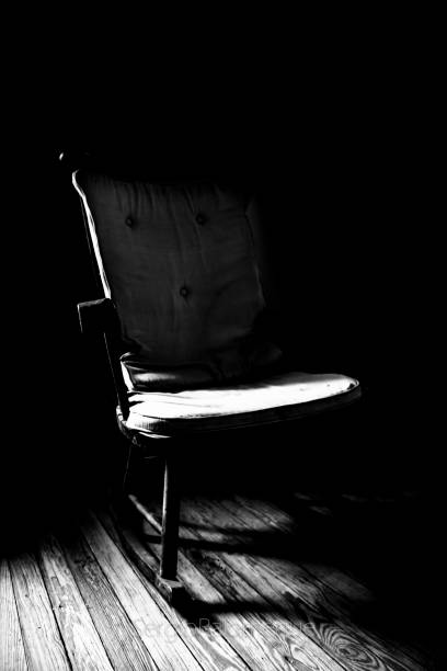 istock rocking chair with natural window light entry 1067443430
