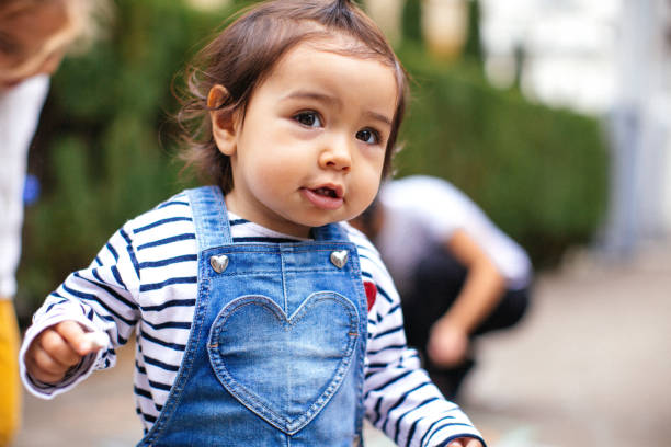 Cute ittle girl plays hopscotch