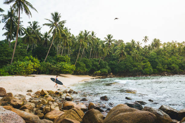 Female surfer relaxes at the beach