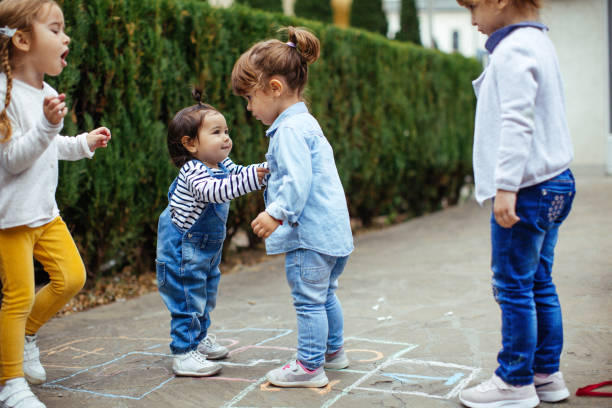 istock Happy kids play hopscotch 1067444092