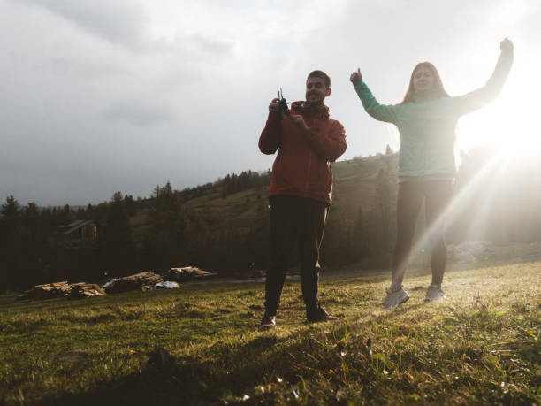 istock Man and woman make selfie by drone during sunrise 1067447008