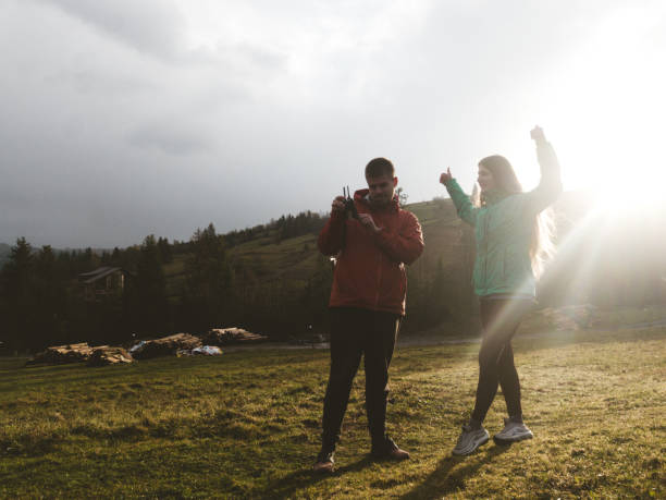 istock Man and woman make selfie by drone during sunrise 1067447018