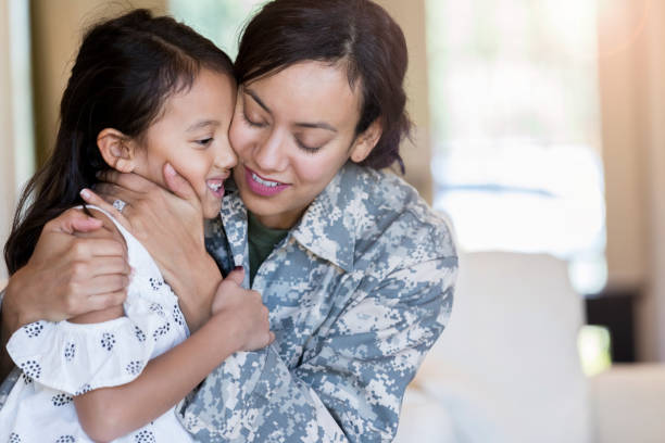 istock Sad army mom embraces daughter 1067448870