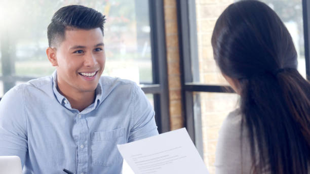 istock Young businessman presents new contract to client 1067449394