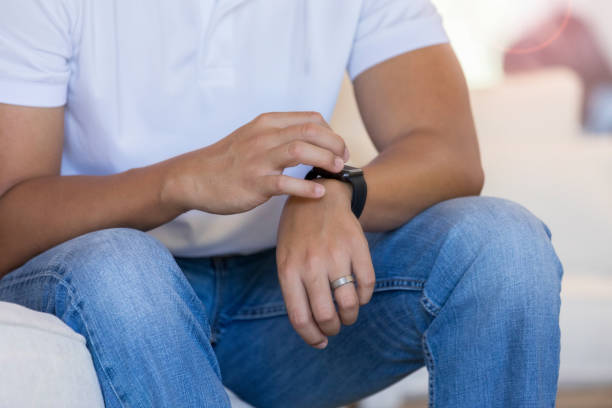istock Man checks time on smart watch 1067451666