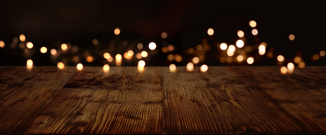 Gold and silver lights on dark rustic wood for a christmas decoration