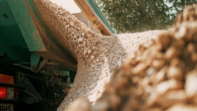 SLO MO Gravel being unloaded at the building site and falling off of the truck