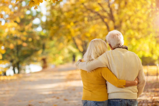 istock Elderly couple together in autumn park 1067467620